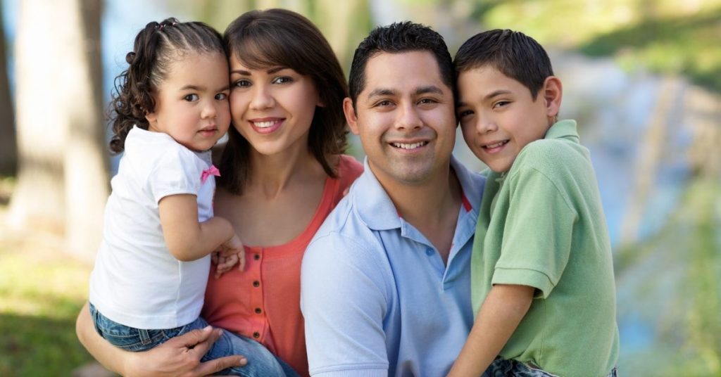 Young family smiling for photo