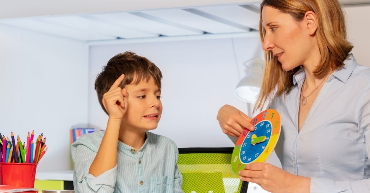 woman showing clock to a boy