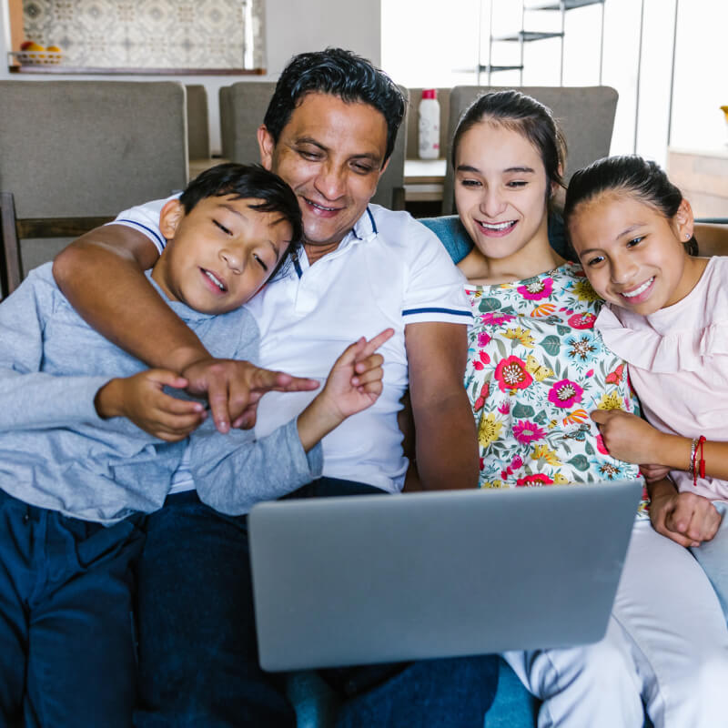 Mexican family and teenage daughter with cerebral palsy making video call with laptop on couch